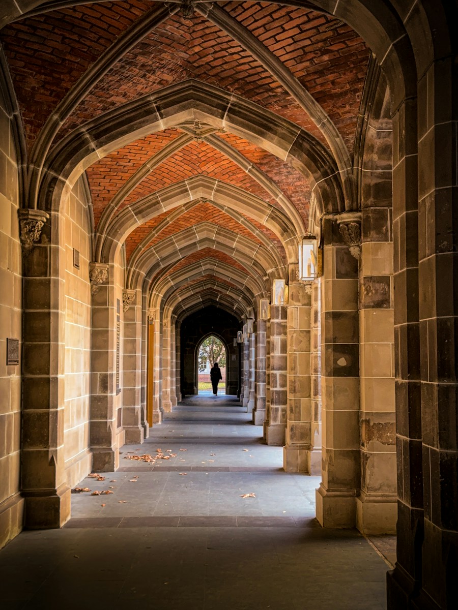 Student walking through a campus archway