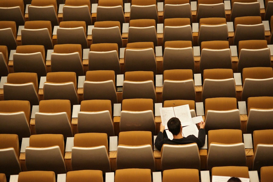 Student reading in a lecture hall