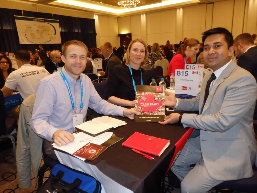 Agent meeting at the Brock University table at an ICEF workshop