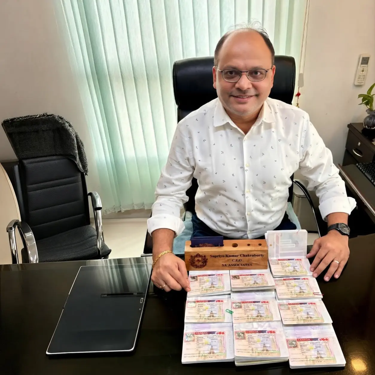 Supriyo Kumar Chakraborty with nine passports carrying Canadian visas received in one day
