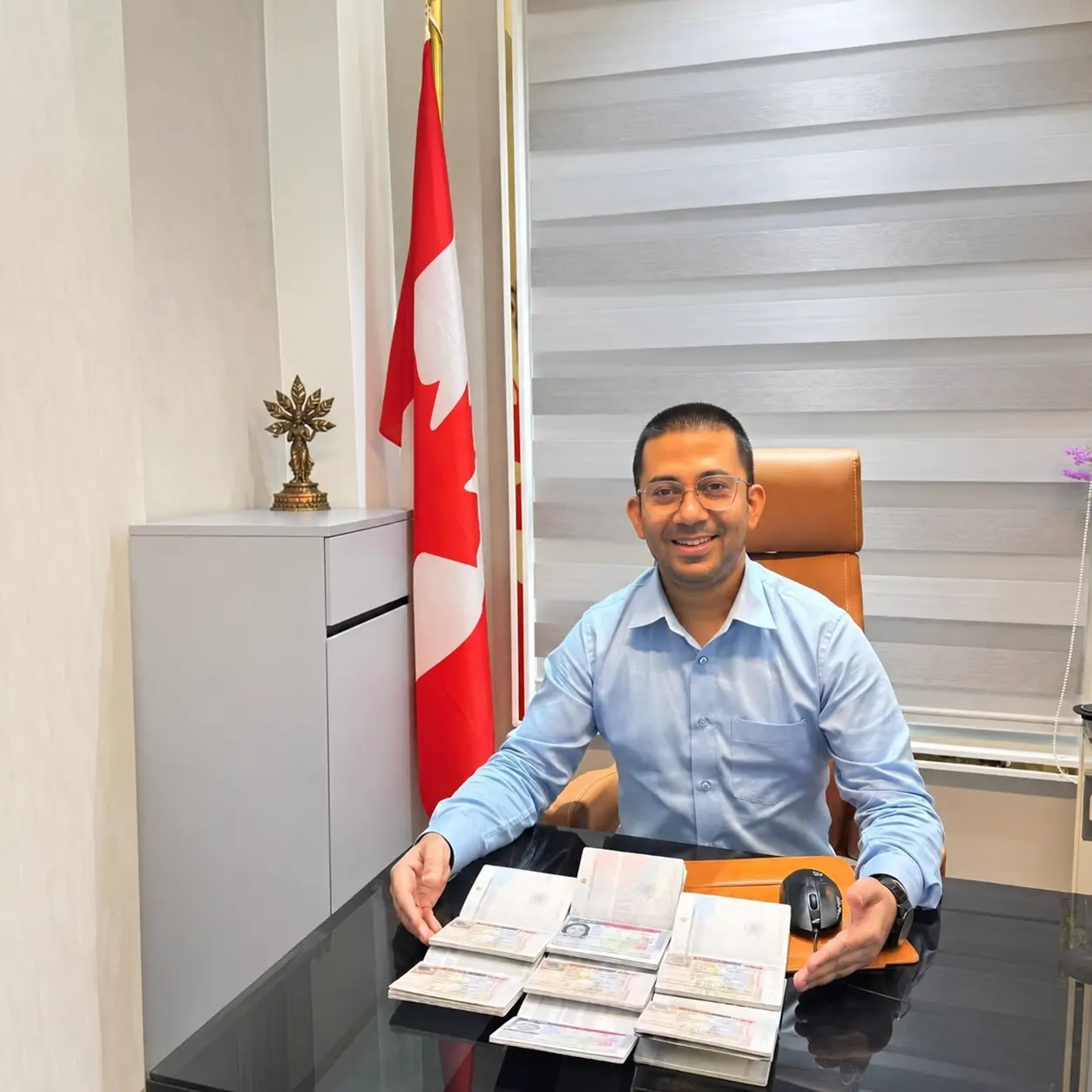 Consultant holding three passports with Canadian visas received in one day
