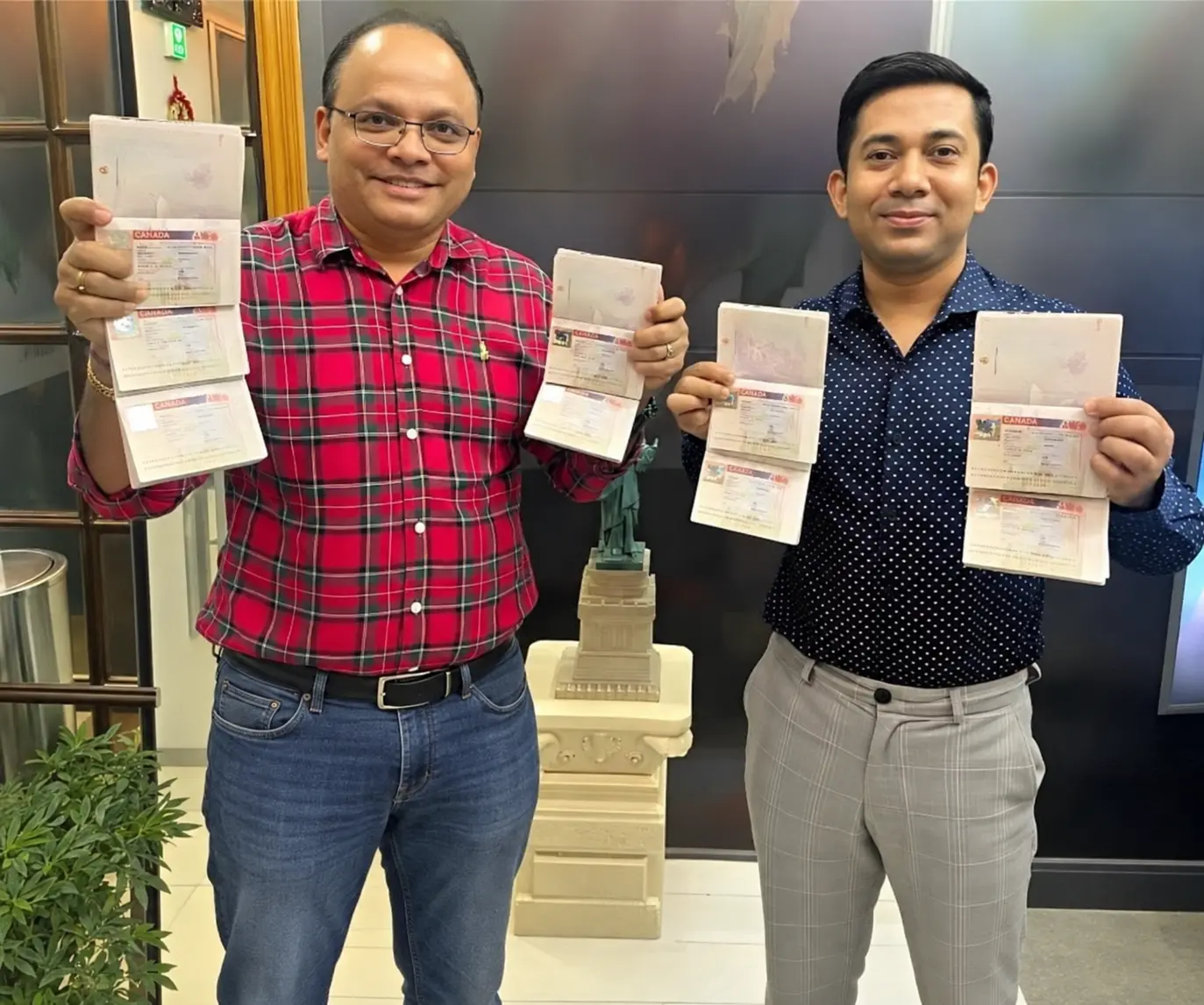 Consultant holding a stack of VFS Global passport return envelopes